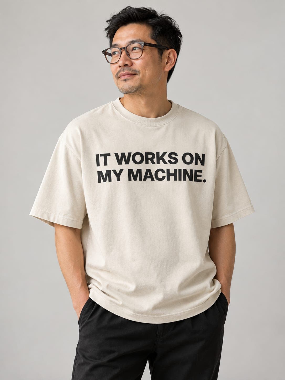 IT WORKS ON MY MACHINE Tee in Faded Bone, worn by a model: IT WORKS ON MY MACHINE. printed center chest. AI-generated mockup.