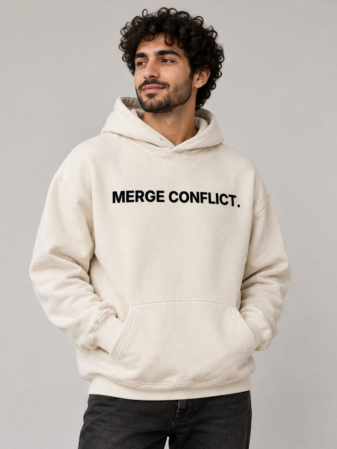 MERGE CONFLICT Hoodie in Pigment Ivory, worn by a model: MERGE CONFLICT. printed center chest. AI-generated mockup.